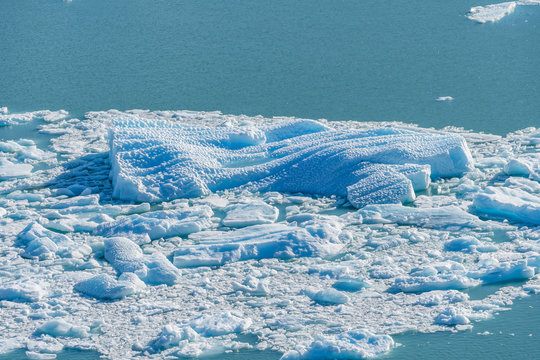 Close up view of blue ice burg floting in the blue aqua lake at Perito Moreno glacier in Los Glaciares National Park, Santa Cruz, Argentina, southern Patagonia ice field