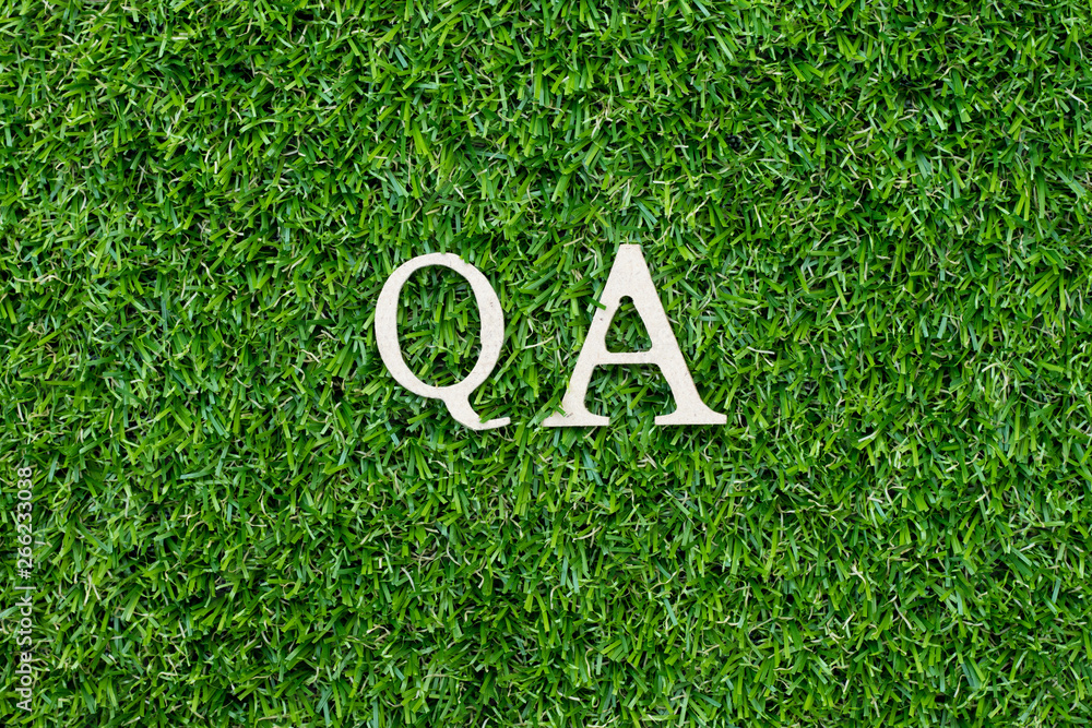 Canvas Prints Wood alphabet letter in word QA (abbreviation of quality assurance or question and answer) on green grass background