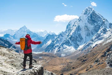 Photo sur Aluminium brossé Ama Dablam Trekker standing at the edge of the mountain cliff and looking to the beautiful view of Mt.Ama Dablam (6,812 m) and Cholatse (6,440 m) view on the way to Cho La pass, Nepal.