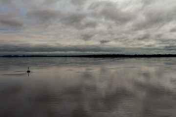 Storm clouds reflected in the waters of the river. Free space to write.