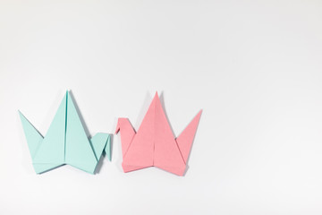 Hand folded origami paper cranes, isolated on a white background