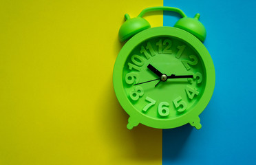 Alarm clock on colorful background