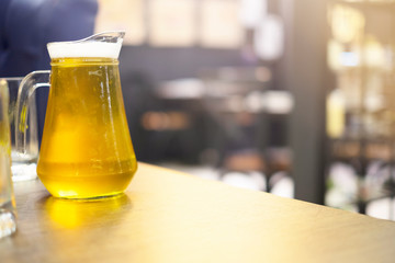 Glass of beer .With wheat and barley and barrels spikes on background .Closeup selective focus