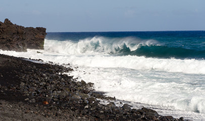 Rough surf  at edge of black sands of Pohoiki  beach