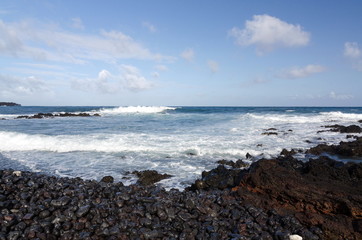 Rough surf  at edge of black sands of Pohoiki  beach