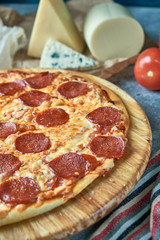 Slice of hot pizza large cheese lunch or dinner crust seafood meat topping sauce. with bell pepper vegetables delicious tasty fast food italian traditional on wooden board table classic in view