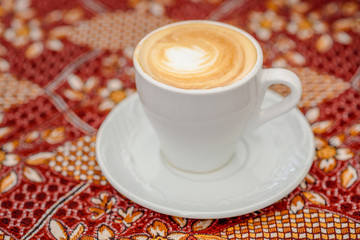 Arabic coffee. Side view latte or coffee or cappuccino.Turkish coffee on the traditional tablecloth.