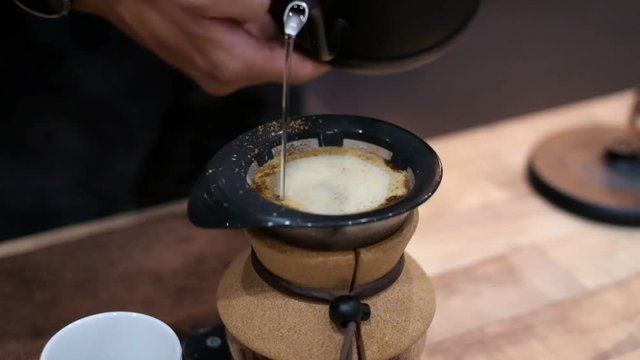 Making coffee drip with hot water, Food and drink concept. Hot water pouring to roasted coffee for fresh drip coffee
