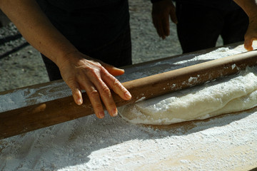 Mochi being rolled flat, before being separated into balls