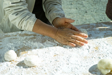 A woman shaping mochi balls ready for the new year