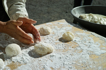 A woman shaping mochi balls ready for the new year - 266243050