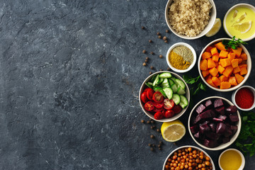 Set of healthy vegetarian ingredients for cooking. Spiced chickpeas, Baked pumpkin and beets, quinoa and vegetables on dark stone background with copy space top view