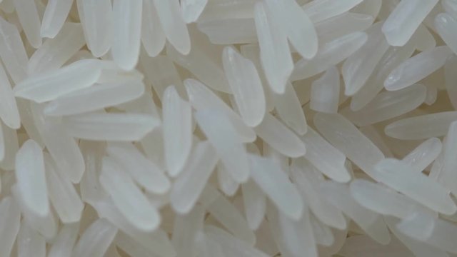 Closeup jasmine white rice, Uncooked products by organic natural food concept, Top view, Slow Motion footage