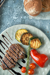 grilled beef steak with vegetables on plate
