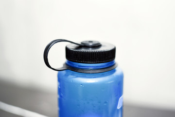 Closeup of blue water bottle with screw-on lid