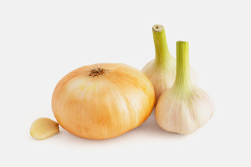 Good quality onion bulb and two heads with garlic clove on white background