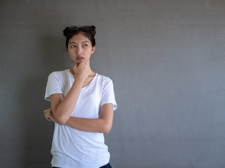 Pretty smiling joyfully female with fair hair, dressed casually, looking with satisfaction at camera, being happy. Studio shot of good-looking beautiful woman isolated against blank studio wall