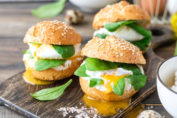 Veggie burger with poached egg and sorrel in a curd bun on rice flour