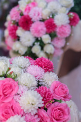 Plastic pink, red and white flowers for wedding ceremony.