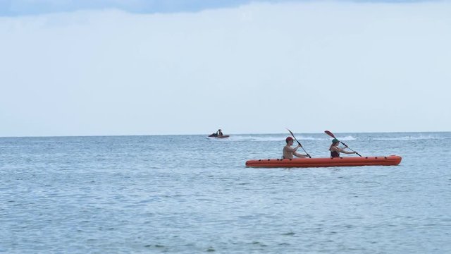 background on the sea floating kayak for two and jet ski