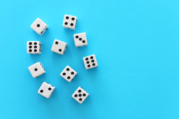 Rolling Dices over blue background. Casino gambling concept