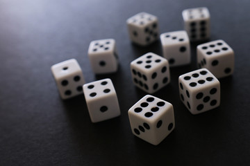 Rolling Dices over black background. Casino gambling concept