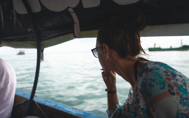 Young female traveler sailing in a local Asian boat