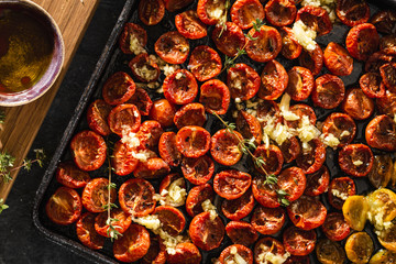 Baked cherry tomatoes in baking tray top view