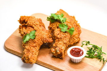Fried chicken crispy on plate wooden board with ketchup on whute background