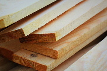 Pile of new wooden boards at construction site
