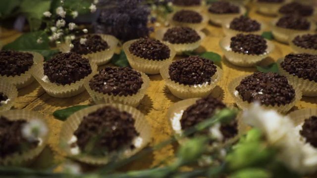 Moving close up of chocolate cakes on the tray. Preparing dessert for wedding serving for dinner of the special night.