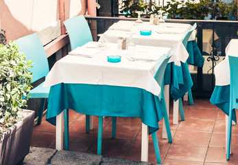 Serving on the table on terrace in the restaurant in Taormina, Sicily, Italy, setting for diner.