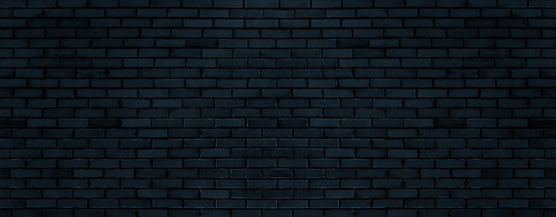 Fototapeta na wymiar Black color brick wall for brickwork background design . Panorama format .
