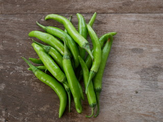 green chili pepper on wooden background