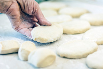 Woman hand making tasty fried patties or pies in kitchen.