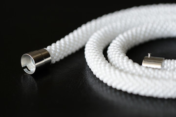 White long beaded necklace on a dark backgroun close up