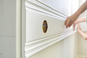 Closeup of gluing wooden white painted plank panel on wall, closeup, carpentry, woodwork, profession, people