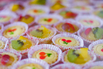 Hand made colorful mini tarts on the table.