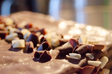 Close up shot of grated white and black chocolate on top of the cake