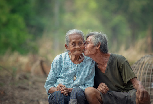 Senior man kissing his woman in a rural.