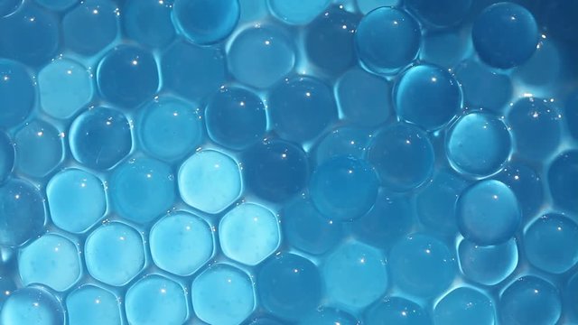 Water blue gel balls. Polymer gel. Silica gel. Balls of blue hydrogel. Crystal liquid ball with reflection. Texture background. Close up macro