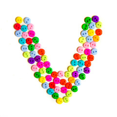 Letter V of the English alphabet made of multi-colored buttons