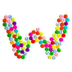 Letter W of the English alphabet made of multi-colored buttons