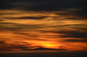 Sunset with extraordinary clouds and orange and gray colours off Glenelg South Australia 