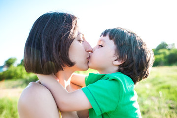 Fototapeta premium Mom kisses the boy.