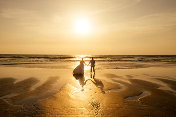 Young couple in love on the beach February 14, St. Valentine's Day sunset Goa India vacation trip .travel new year in a tropical country. freedom concept