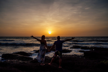 Fototapeta premium Young couple in love on the beach February 14, St. Valentine's Day sunset Goa India vacation trip .travel new year in a tropical country. freedom concept