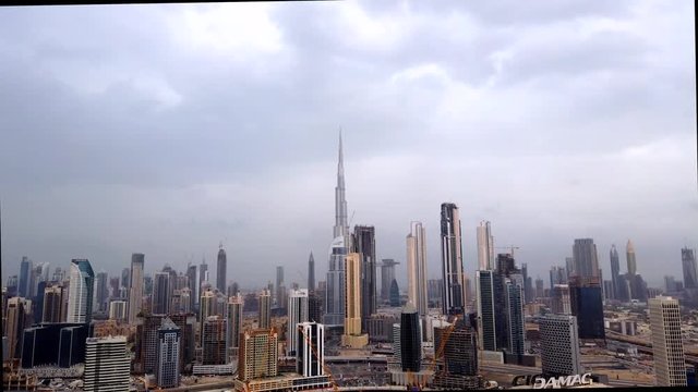 Time lapse of the clouds moving over Downtown Dubai with Burj Khalifa the tallest tower in the world in the center