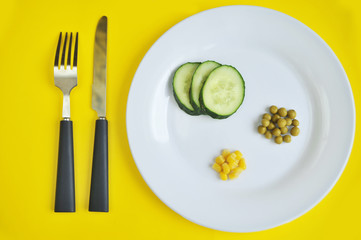 Fototapeta na wymiar Conceptual image of diet theme. Plate with some food. The word diet made from peas.