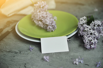 Decorated stone table with cutlery and flowers.